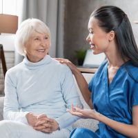 nurse-assisting-with-elderly-woman-at-home